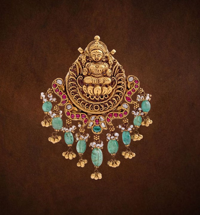 Deity Lakshmi crafted Pendant in Kundan and Nakshi yellow gold with Uncut Rubies Polki & Gold balls