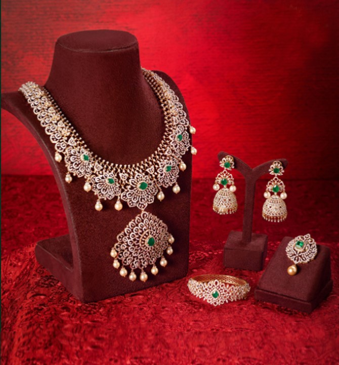 Diamond Long Haram Necklace Jhumka Earrings Diamond Bracelet and Mangtika all radiate the beauty of dazzling diamonds and pear