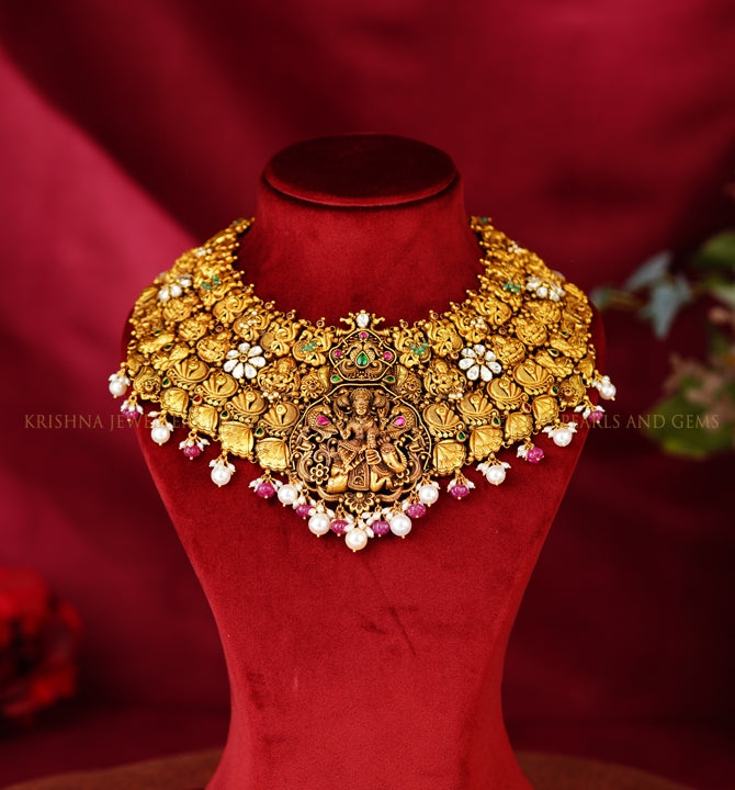 Gold Choker Featuring Laxmi Devi and Peacock Motif With Ruby Beads Dropping Pearls.