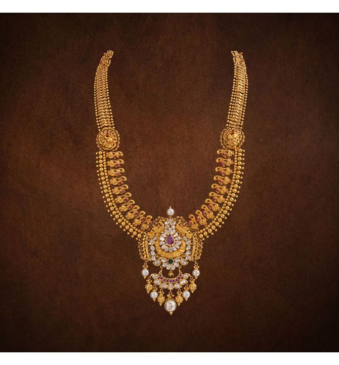 Gold peacock necklace with Polki diamond and ruby centered pendant